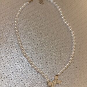 Elegant Pearl Necklace with Gold Bow